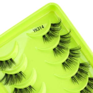 Macro shot of thick curled half false eyelashes in YK314 style on green tray