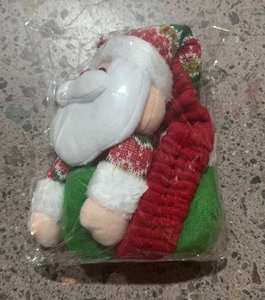 Detail view of Santa Claus Christmas plush doll ornament in clear plastic packaging