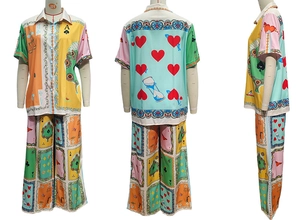 Detail of short sleeve shirt and wide leg trousers featuring bold poker card patterns