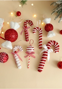 Close-up of red and white Christmas candy ornaments with glitter and festive ribbons