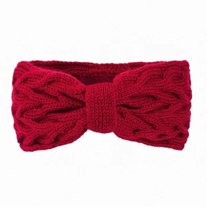 Close-up of red cable knit headband showing intricate bow detail and warm winter texture