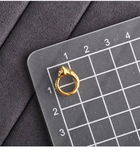 Detailed scale measurement of a textured golden leopard head pendant for DIY jewelry