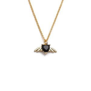 Detailed view of a golden necklace featuring a black heart pendant with angel wings