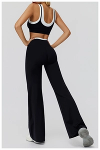 Detail of cross-back yoga top and high-waist flared pants with contrast trim