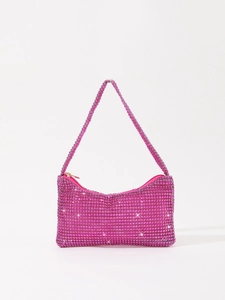 Macro detail of hot pink rhinestone mesh fabric on a stylish mini evening underarm bag