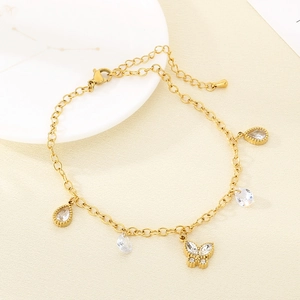 Detail of gold beach style anklet with butterfly charms and water drop crystals