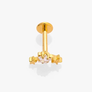 Macro shot of gold G23 titanium labret stud featuring a three-star cluster with zircon