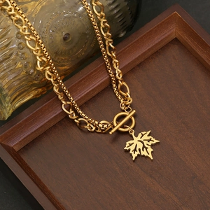 Gold-toned layered maple leaf necklace with box and Cuban chains and OT toggle clasp