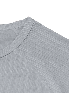 Macro shot of grey waffle knit fabric texture showing breathable honeycomb pattern stitching