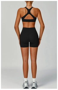 Rear view of black high-waist fitness shorts and hollow-out sports bra for women