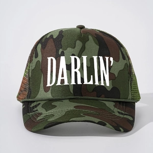 Front view of forest camo trucker hat with white DARLIN' print and green rope detail