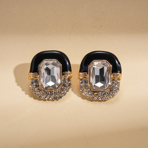 Macro detail of vintage black enamel earrings with gold plating and sparkling crystals