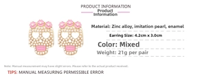 Detail view of pink skull earrings with pearls and dimensions 4.2cm by 3.0cm