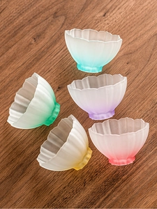 Detailed top view of five frosted lotus glass tea cups with colorful gradient petals