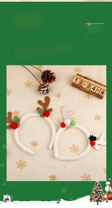 Detail of Christmas reindeer antler headbands with plush balls and gold glitter finish