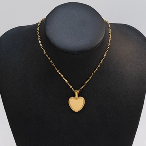 Detail of 18K gold-plated heart pendant on a black bust display for elegant presentation