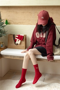 Close-up of red cashmere crew socks with Keep your head up embroidery for festive wear