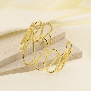Irregular wavy curve stainless steel open bangle in gold finish on stone base