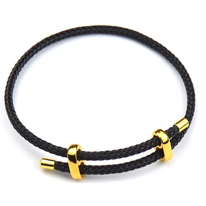 Adjustable black braided rope bracelet with three polished gold metal accents on white background