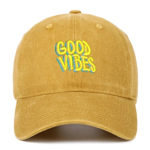 Close-up of vibrant multi-color GOOD VIBES 3D embroidery on mustard yellow washed cotton cap