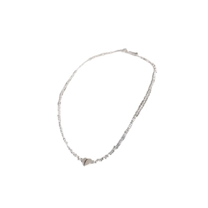 Silver crushed metal necklace featuring a minimalist heart pendant on a white background