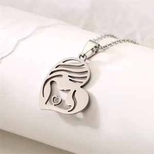 Macro detail of silver heart necklace with mother and child silhouette pendant