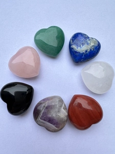 Top view of seven assorted 3cm heart-shaped natural gemstones with polished finish