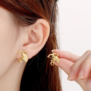 Minimalist golden ginkgo leaf stud earrings in stainless steel with brushed metal finish