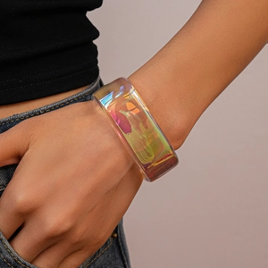 Close-up of chunky iridescent acrylic bangle featuring a unique irregular geometric design