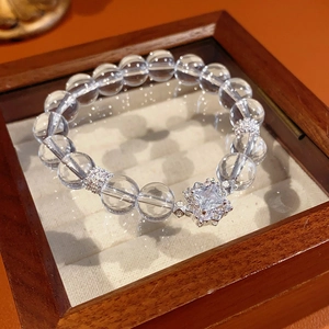 Detail of beaded crystal bracelet featuring a large square center stone and silver accents