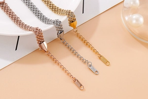 Detail of multi-layer stainless steel bracelets in gold, silver, and rose gold finishes