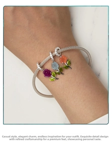 Detail of s925 silver mesh bracelet with UV color-changing rose charms on wrist