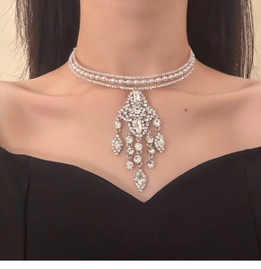 Detail of a luxury three-layer choker featuring sparkling rhinestones and white pearls