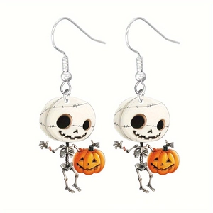 Detail showing a cute cartoon skeleton holding a pumpkin lantern on acrylic earrings
