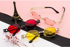 Detail of steampunk sunglasses with hollow geometric metal temples and colorful lenses