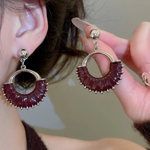 Detail shot of vintage leather round stud earrings with silver beads and metallic finish