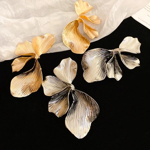 Vintage gold and silver metallic flower stud earrings with brushed petal texture