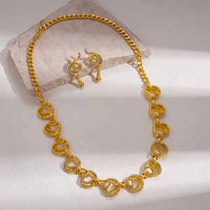 Luxurious gold snake jewelry set with necklace and earrings featuring sparkling rhinestones