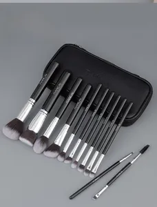 Detailed view of 13 professional black and silver makeup brushes with leather pouch