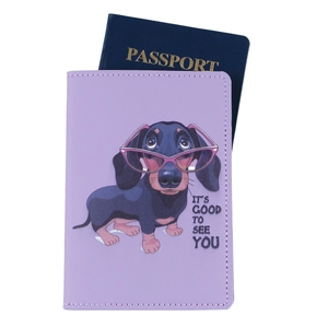 Detail of purple faux leather passport holder with cartoon dachshund and printed quote