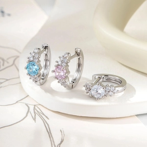 Three pairs of elegant silver hoop earrings with clear and colorful zircon stones