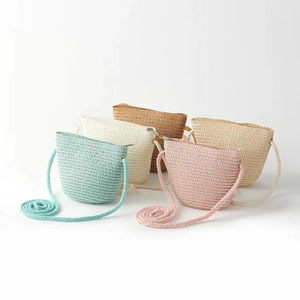 Collection of five colorful woven straw crossbody bags for girls in various pastel shades