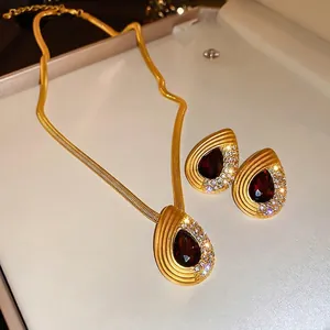 Vintage gold teardrop jewelry set with red gemstones and white zircon necklace and earrings