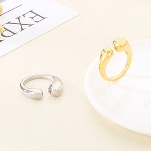 Detail shot of gold and silver irregular geometric rings on minimalist props
