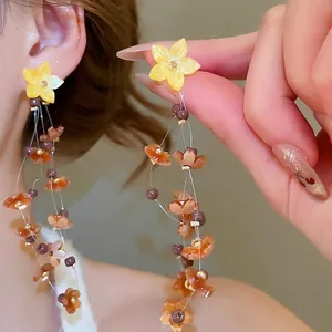 Floral resin earrings with tassel beads for beach vacations and minimalist bohemian style