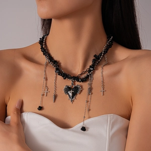 Detail of gothic choker with black crushed stone, heart cross pendant and silver tassels