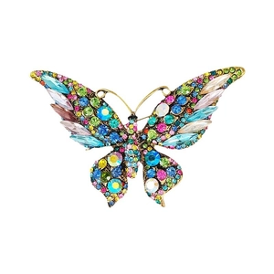 Vintage gold butterfly brooch encrusted with colorful crystals on a white background
