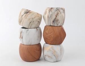 Detail of small ceramic succulent pots featuring wood grain and marble patterns