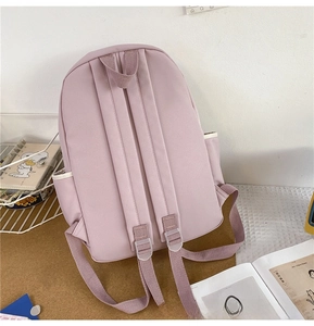 Detailed back view of light pink cute schoolbag with rabbit ears and side pockets