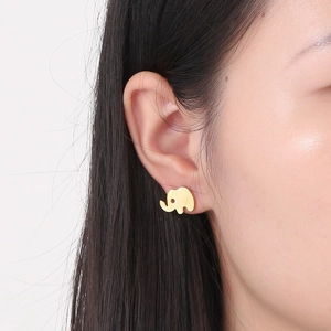 On-ear view of cute golden stainless steel elephant stud earrings with a sleek finish